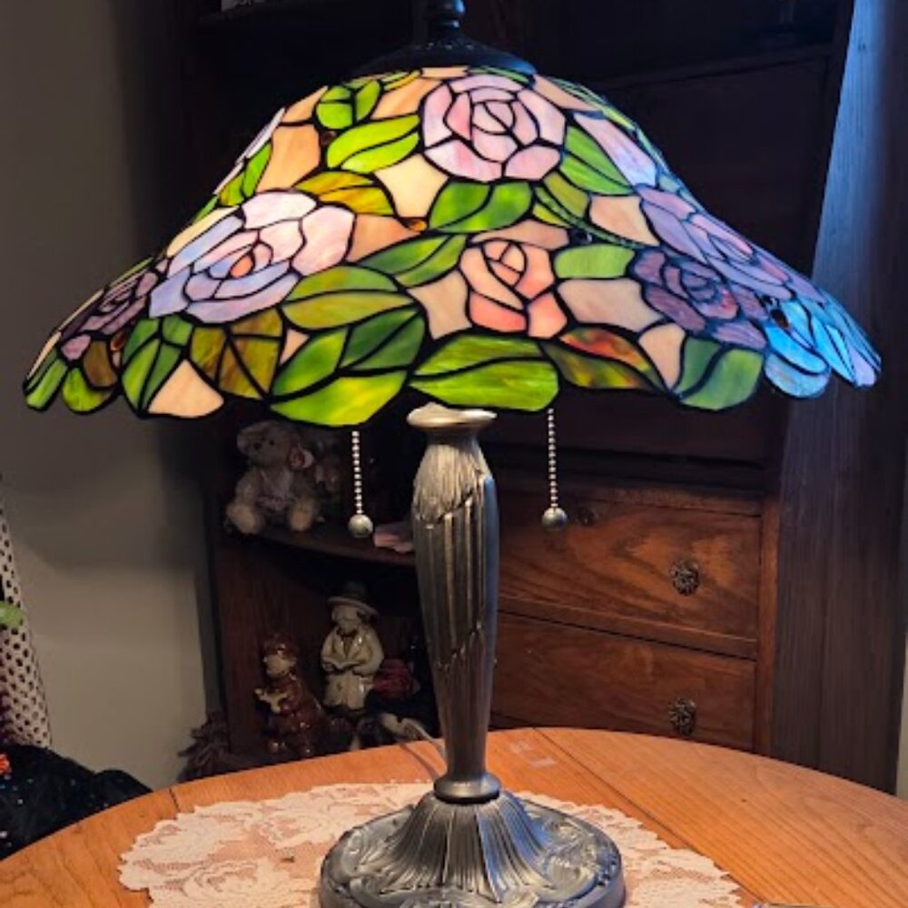 Tiffany-style stained glass table lamp with a rose pattern.